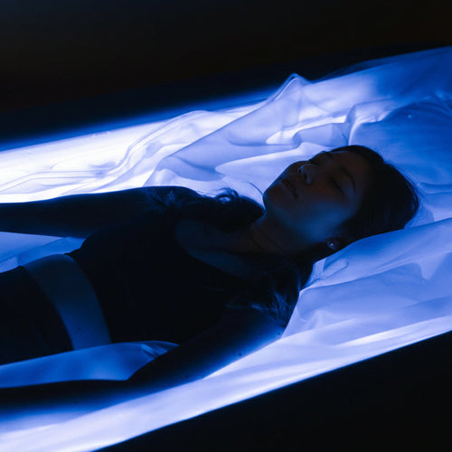 Person lying down in a dry float bed.